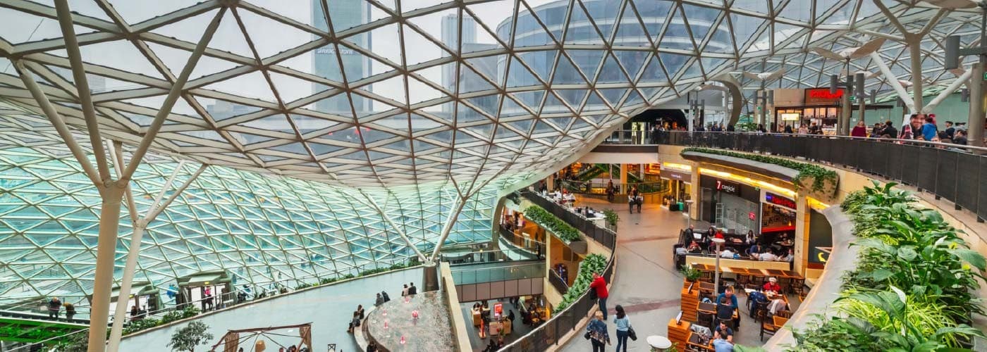 A beautiful shopping center right in a downtown center of commerce overlooking a street view.